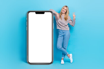 Full length photo of pretty lady wear stylish clothes big white panel mirror poster banner empty space isolated on blue color background