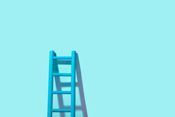 Development concept. Ladder up on blue background with copy space.
