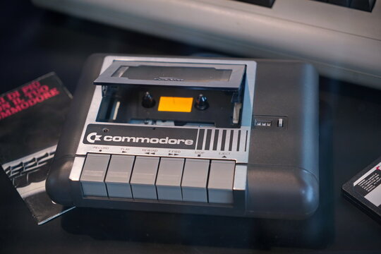 Rimini, Italy, June 2023: a vintage console Commodore 64 with an old tape cassette in it to play a video game.