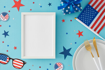 Obraz premium Idea for patriotic festivities on July 4th. Top view flat lay of plates, cutlery, gift box, american flag, paper props, stars on light blue background with blank frame for advert or text
