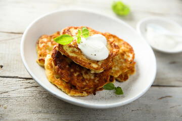 Traditional homemade latkes with sour cream