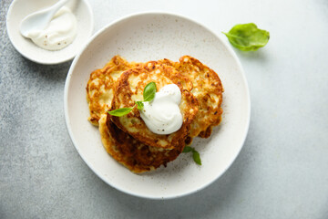 Traditional homemade latkes with sour cream