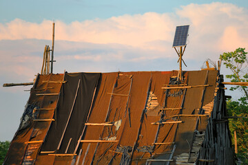 Photovoltaics instalation on a old destroyed, devastated roof - 614694019