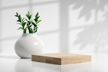 Kitchen counter with wooden podium tray or chopping board and a ceramic vase with green plants.