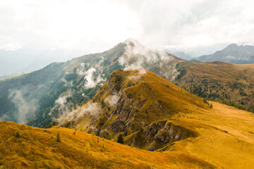 Famous Giau Pass, where the slopes are bedecked with a majestic mountain range, draped in a misty...