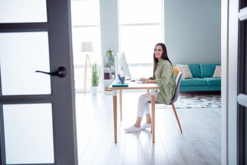 Portrait of charming woman ceo boss sitting chair indoors office room analyzing project welcome partner door entrance workplace
