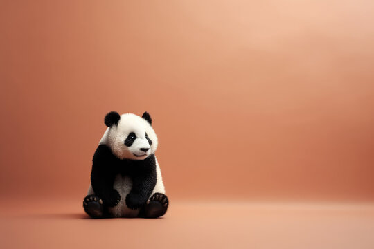 Small toy fluffy panda isolated on orange background with copy space. Japanese minimalist style. Cute panda sitting. Generative AI photo imitation.