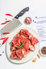 Paper culinary recipe for preparation pork. Raw ingredients includes pork loin pieces, spices, herbs