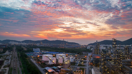 Crude Oil Refinery Plant Steel Pipe line and Chimney and Cooling tower, Chemical or Petrochemical factory plant power plant, Petrochemical tower tank industry at sunset