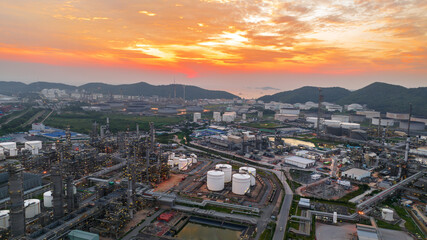 Fototapeta na wymiar Crude Oil Refinery Plant Steel Pipe line and Chimney and Cooling tower, Chemical or Petrochemical factory plant power plant, Petrochemical tower tank industry at sunset