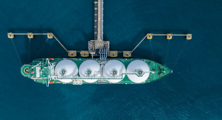 LNG (Liquified Natural Gas) tanker anchored in Gas terminal gas tanks for storage. Oil Crude Gas Tanker Ship. LPG at Tanker Bay Petroleum Chemical or Methane freighter export import transportation 