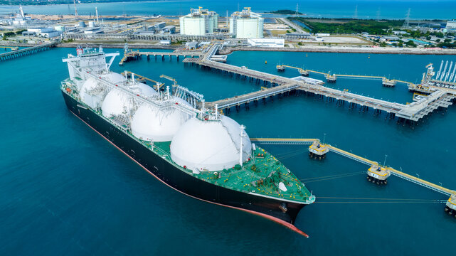 LNG (Liquified Natural Gas) tanker anchored in Gas terminal gas tanks for storage. Oil Crude Gas Tanker Ship. LPG at Tanker Bay Petroleum Chemical or Methane freighter export import transportation