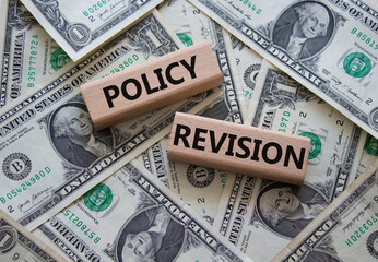 Policy revision symbol. Concept word Policy revision on wooden blocks. Beautiful dollar background. Business and Policy revision concept. Copy space