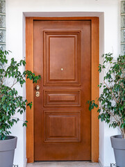 A contemporary house with brown wood entrance door. Travel to Athens, Greece.