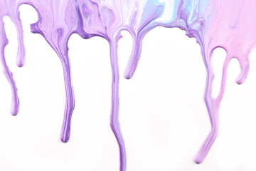 Paint drops flowing down on white paper. Lilac purple ink blots abstract background
