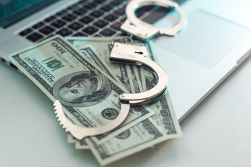 The handcuffs are on hundred-dollar bills. Power and bribery. Criminal ransom. Criminal earnings. Business concept. The concept of wealth
