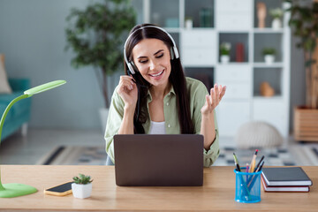Photo of charming cheerful corporate lady communicate clients headset microphone wireless netbook...