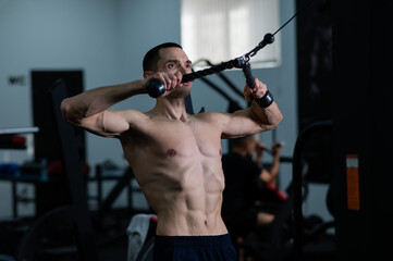 Fototapeta na wymiar Man Thrust of the upper block to the chest in the gym.