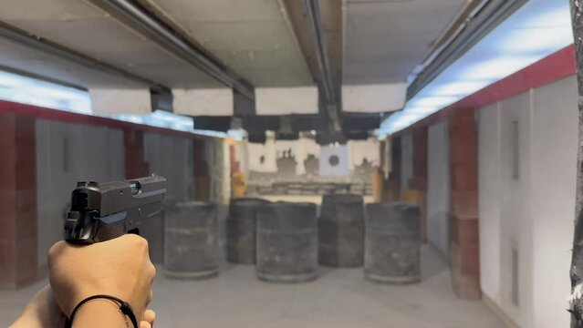 Woman Shooting with a 9mm Handgun in Shooting Range in Switzerland.