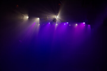 purple lights and spotlights on stage 
