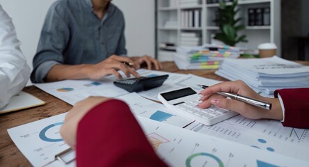 Team Of Business working at office with documents on his desk, doing planning analyzing the use a financial calculator, business plan investment, finance analysis concept