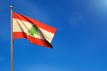 Lebanon. Flag blown by the wind with blue sky in the background