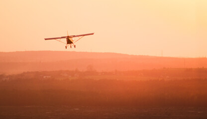 Fototapeta na wymiar airplane landing at sunset