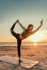 Fototapeta na wymiar Balance and harmony, a young woman practicing doing yoga asana exercises.