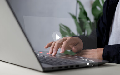 Man using laptop for streaming online, watching video on internet, live concert, show or tutorial.