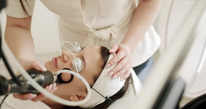 Woman getting LPG hardware massage at the beauty clinic. skin rejuvenation concept. Beautician cosmetologist doing procedure fractional microneedle mesotherapy rejuvenation with laser technology.