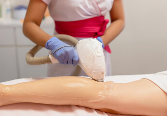 Hair removal laser treatment in a beauty salon by a female master 