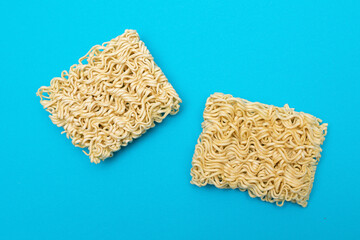 Uncooked Instant Noodles on Blue Background. Raw Pasta. Dry Asian Fast Food. Quick Lunch