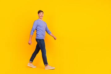 Fototapeta na wymiar Full length body size photo man smiling walking forward isolated over yellow bright color background