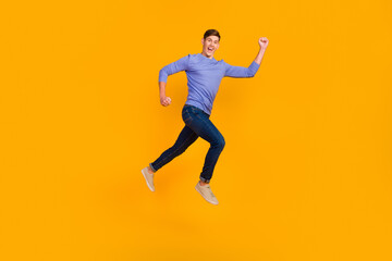 Full length side profile body photo of jumping man run fast rushing wearing casual jeans shirt isolated bright background