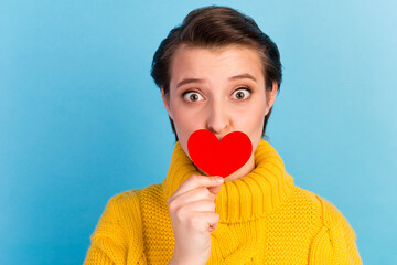 Photo of cute lady girlfriend close mouth little red paper card heart isolated on blue color background
