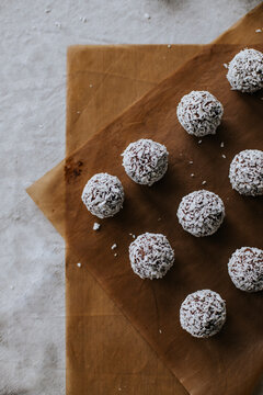 High angle view of coconut balls on wax paper