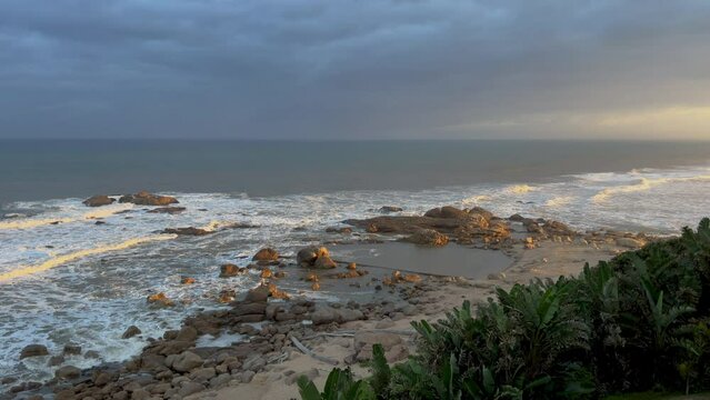 Wild beach with waves breaking on rocks, North Coast, Kwazulu Natal South Africa
