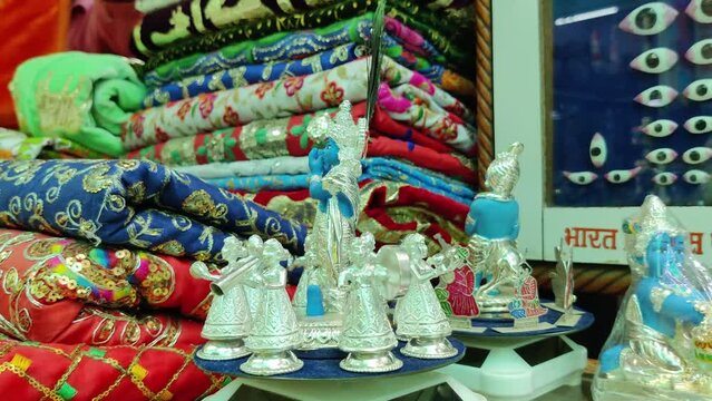 moving idol of lord krishna along with gopis, rotating round. Kanha is playing flute and making gopies dance. beautiful piece of god made of silver. captured at Nathdwara, Rajasthan. on June 03 2023