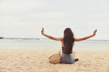 beach woman freedom sand female sitting vacation nature sea travel smile