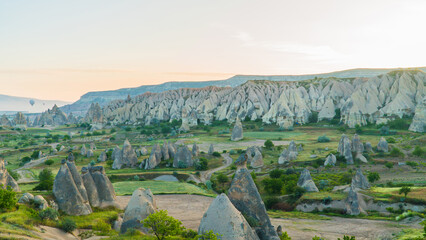 Cappadocia Turkey. Hot air balloons flying over fairy chimneys at sunrise in Cappadocia. Travel to Turkey. Touristic landmarks of Turkiye. Selective focus included.