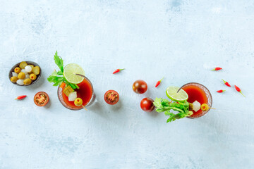 Bloody Mary cocktail with garnish panorama, overhead flat lay shot with copy space. Two glasses of spicy tomato juice with alcohol, lime, pickles © CookShootsFood