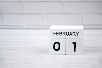 White wooden perpetual calendar showing the 1st of February.