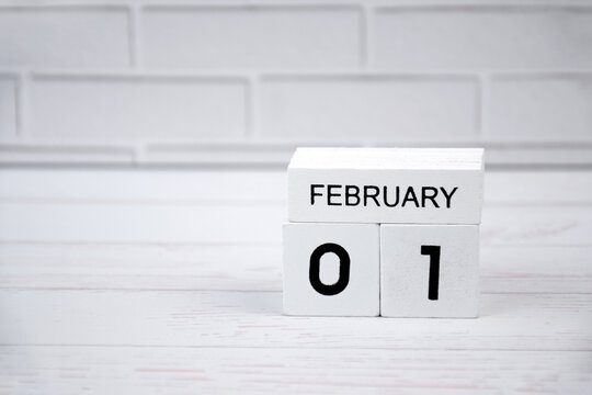 White wooden perpetual calendar showing the 1st of February.