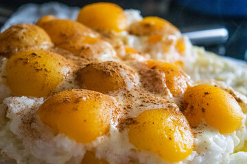 rice with pudding and peaches and cinnamon