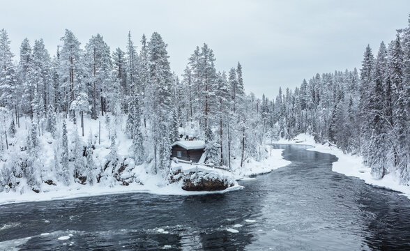 Winter in Finland; landscape in Oulanka National Park with the Kitkajoki river and snow covered boreal forest