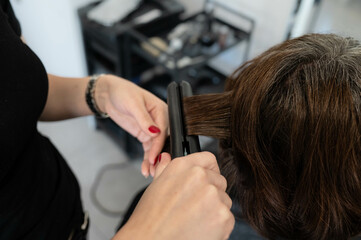 Perfect curls in the making: A professional salon capturing the art of hair curling, adding elegance and glamour to any look.