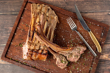 Grilled lamb chops on a wooden serving plate