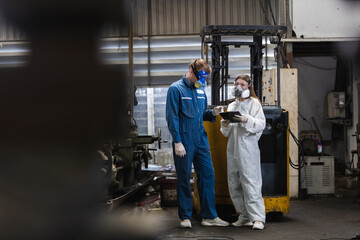 Portrait of Team inspector wearing chemical protective mask and hazmat suit examining chemistry in industrial. Analysing harmful substances to human body and environment.