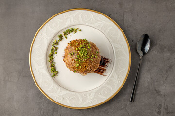 Fried ice cream sprinkled with peanuts on a white porcelain plate