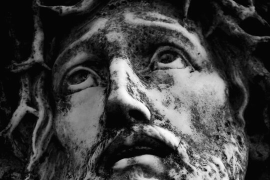 Close up of antique statue Jesus Christ as symbol of love, faith and religion.. Horizontal image.